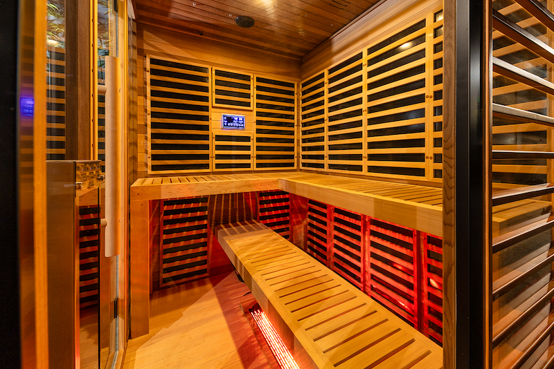 OBNOVA 4-5 PERSON SAUNA showcasing the red cedar interior large l shaped dual tier seating and red light tubes